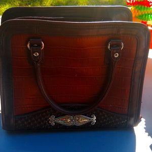 Brown leather purse with accents.